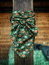 Load image into Gallery viewer, Double sided wild rag. Rich cactus floral print with deep desert greens and warm sunset orange blooms.
