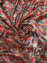 Load image into Gallery viewer, Rich red paisley with hints of navy, cream, greens, and gold. Med weight charmeuse satin fabric.

