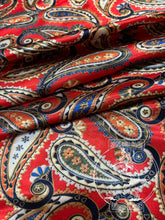 Load image into Gallery viewer, Rich red paisley with hints of navy, cream, greens, and gold. Med weight charmeuse satin fabric.
