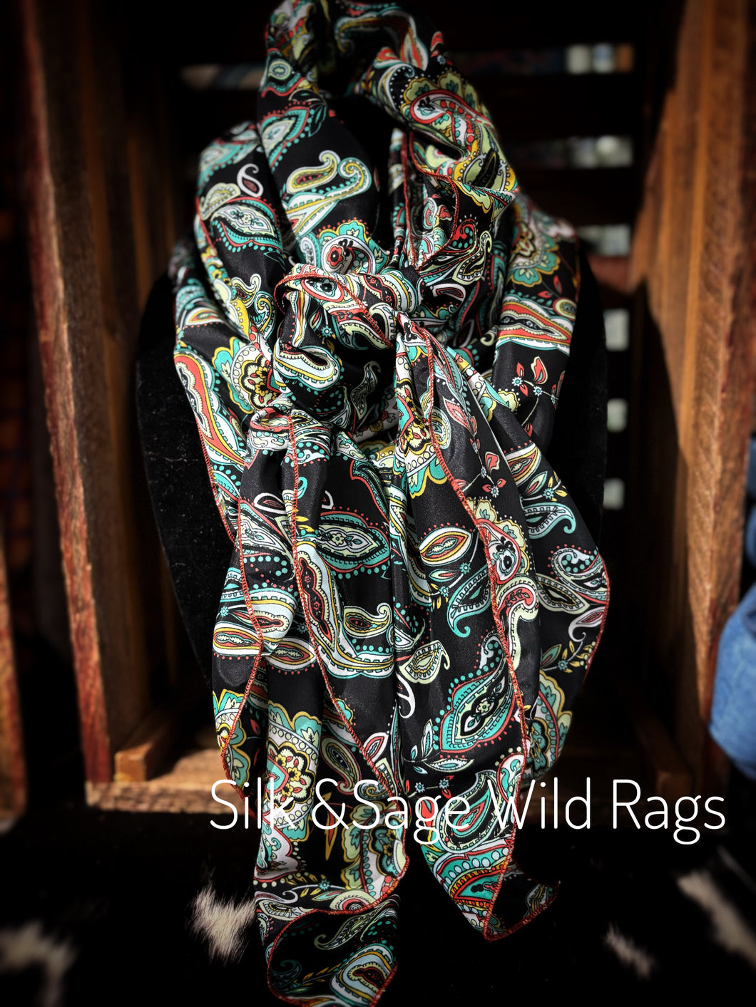 Bold colors of turquoise, red, blue, green orange, mustard yellow. Paisley floral print on a soft peach skin.