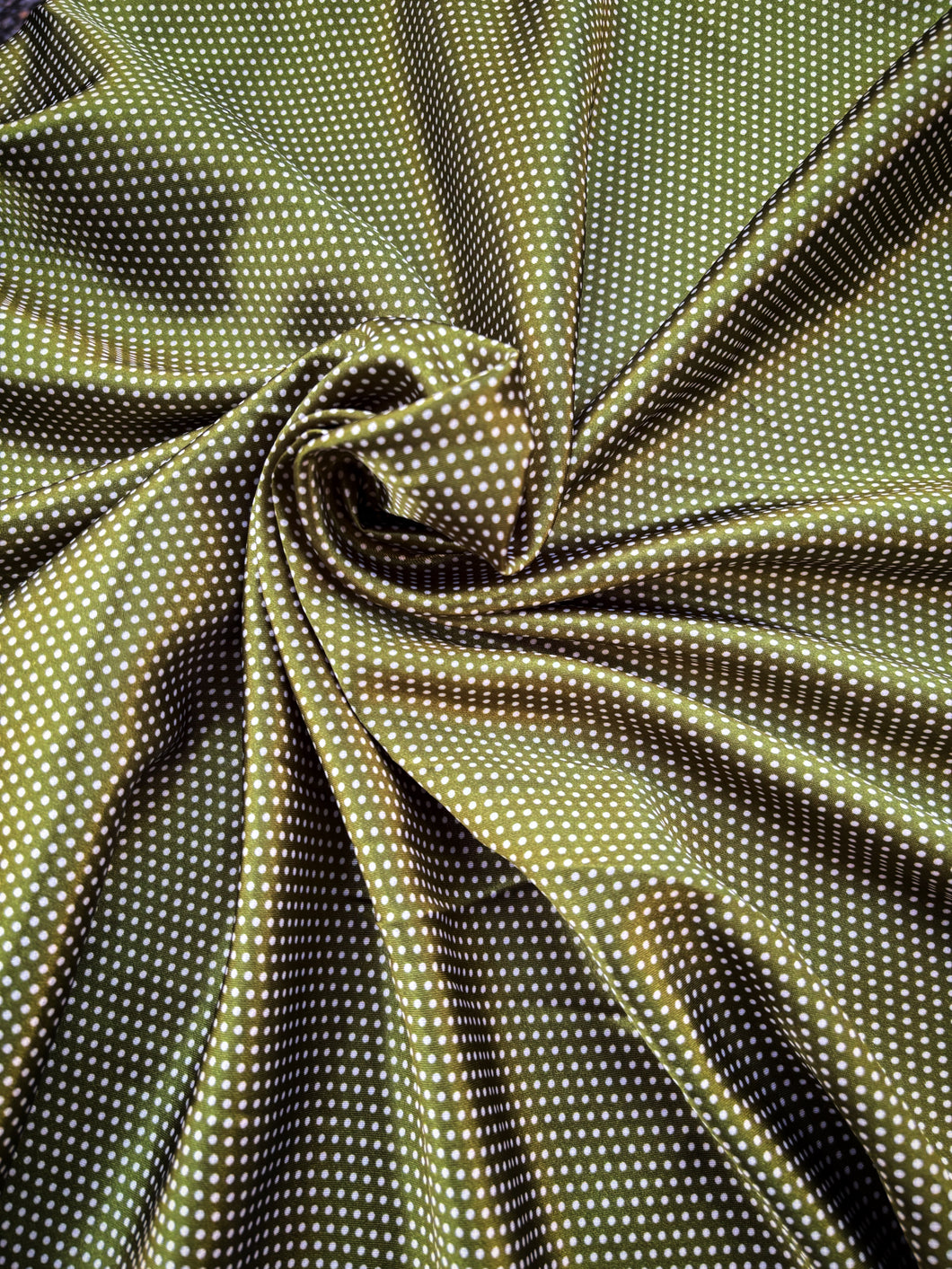 Olive green with A white pin dot print on silky charmeuse.