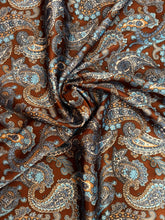 Load image into Gallery viewer, Deep brown, tan and blue paisley on a silky charmeuse satin fabric.
