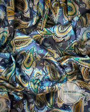 Load image into Gallery viewer, Beautiful blue with green, turquoise, and white paisley design on a soft satin charmeuse fabric.
