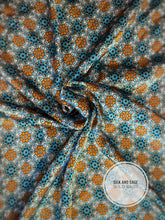 Load image into Gallery viewer, Super fun turquoise, blue, teal, gray and orange floral print on a silky charmeuse fabric.
