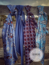 Load image into Gallery viewer, Light sky blue with white, tan, and a hint of pinkish mauve tone paisley on a silky charmeuse.
