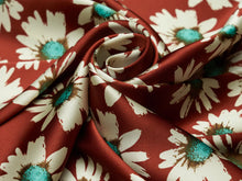 Load image into Gallery viewer, Deep rusty red, tan and turquoise super fun daisy floral silky charmeuse fabric.
