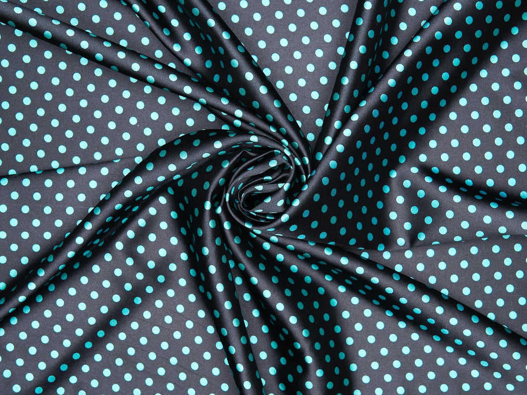 Fun yet sophisticated small polka dot prints. Deep black with teal dots on silky charmeuse fabric.