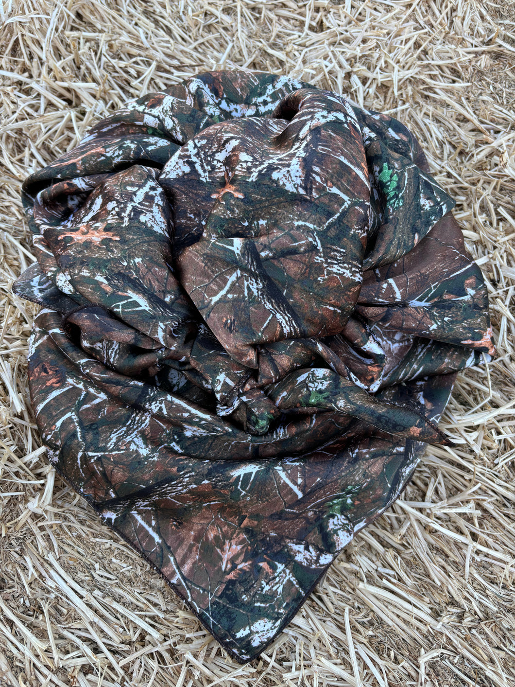 Bare timber style camo with mossy green, brown and cream tones, cream with a hint of light orange tones. Soft charmeuse satin fabric.