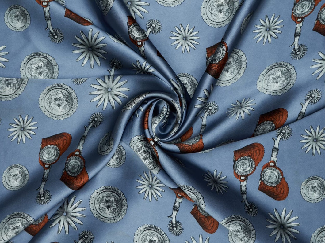 Elegant spur and concho print. Light blue, silver and  black silky charmeuse fabric