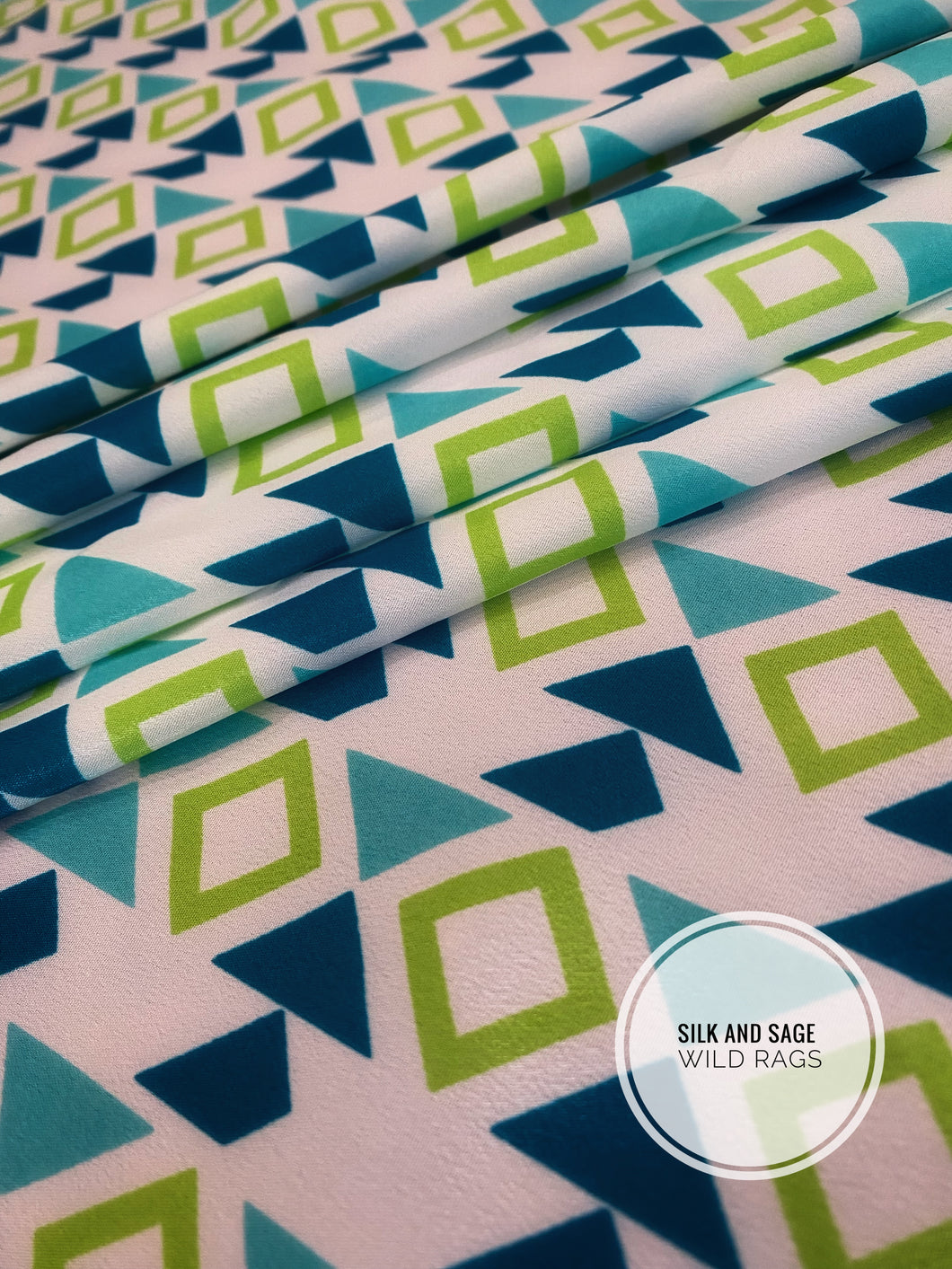 Boho, tribal, Aztec print. Light blue, teal, turquoise, lime green and white tone silky cdc fabric.