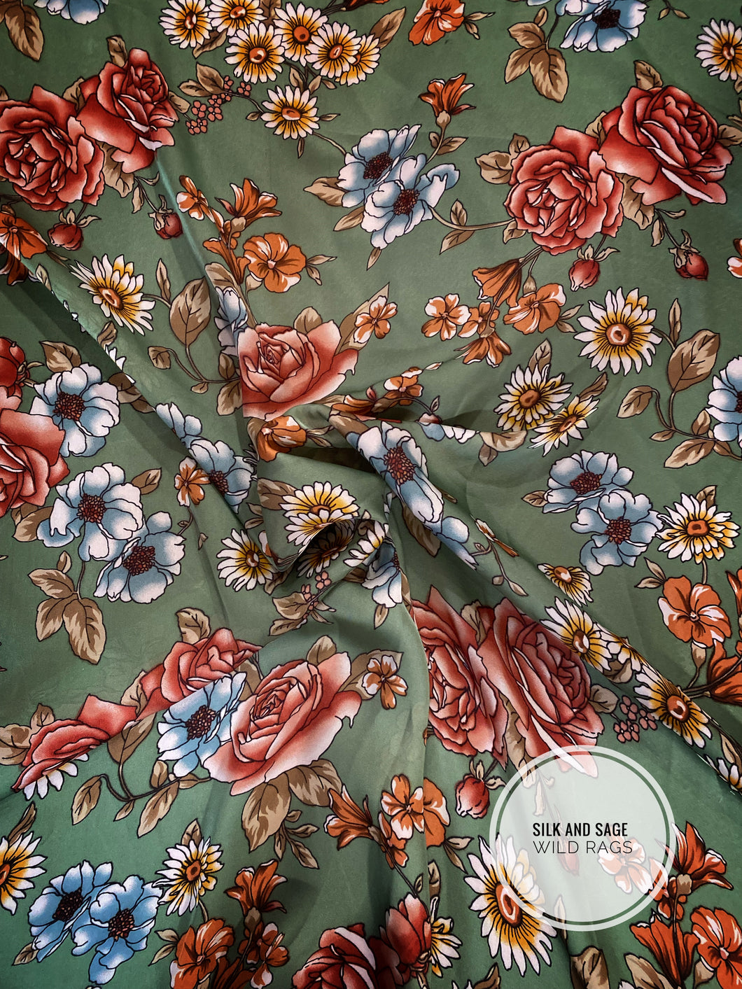 Sage green with rust, orange, gold, mustard,  blue  floral print. Made of silky soft, light weight satin fabric.